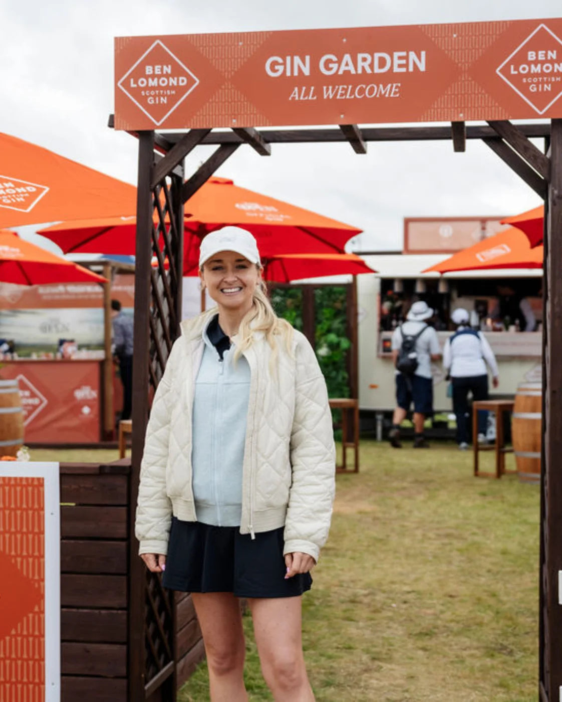 Woman standing in front of a 'Gin Garden' sign with Ben Lomond Gin branding.