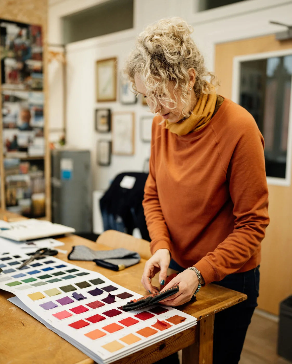Person in an office setting looking at color swatches
