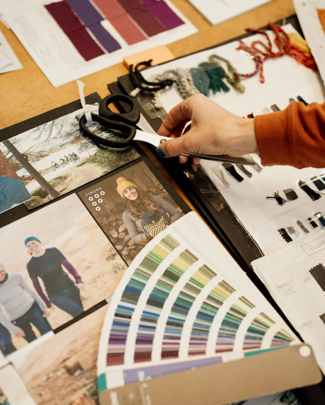 Person working with photos and color swatches on a table