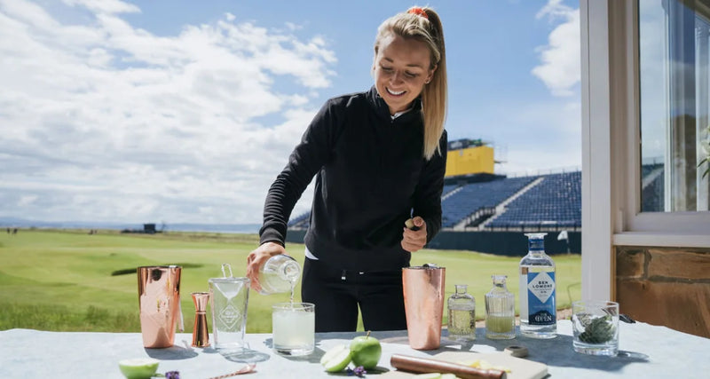 Woman preparing a cocktail at a golf course with a scenic background