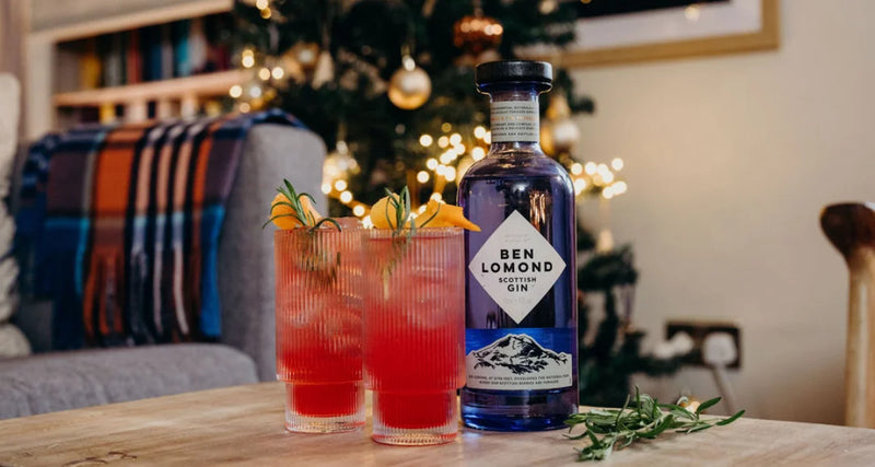 Ben Lomond gin bottle with two cocktails on a table in a festive setting.