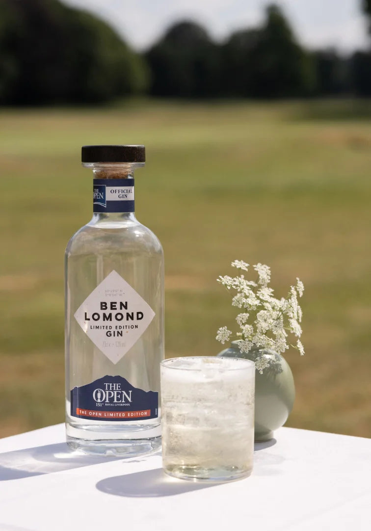 Ben Lomond gin bottle with a glass of gin and tonic on a table outdoors.