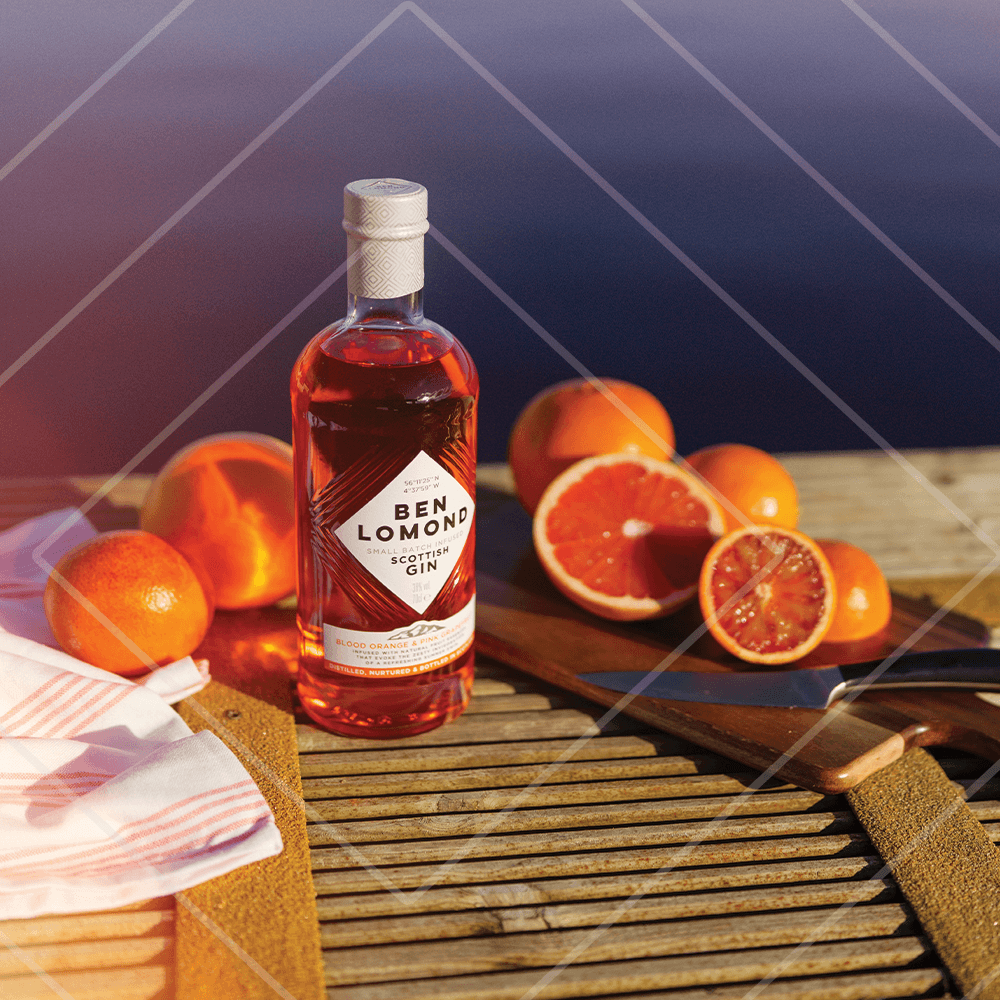 Bottle of Ben Lomond gin with oranges on a wooden surface