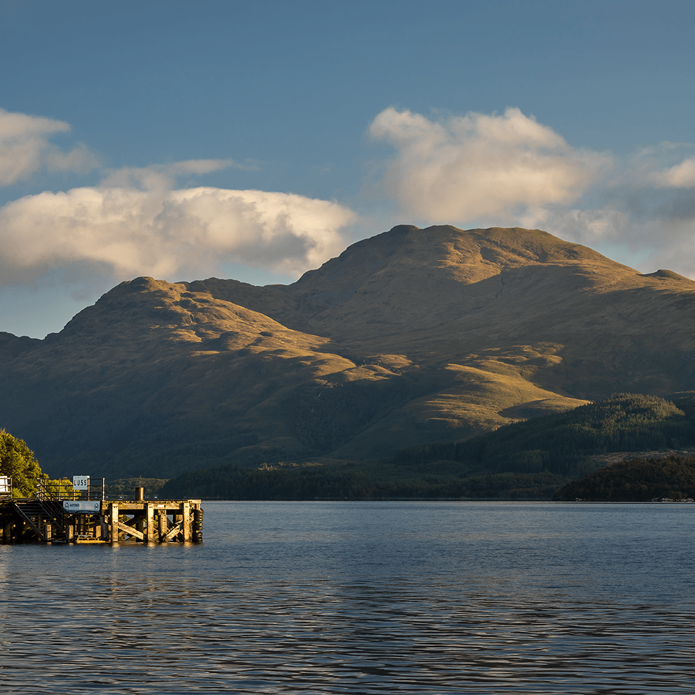 Mountain range with a dock in the foreground on a calm lake