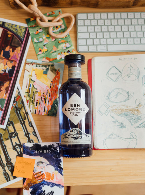 Bottle of Ben Lomon gin on a desk with stationery items