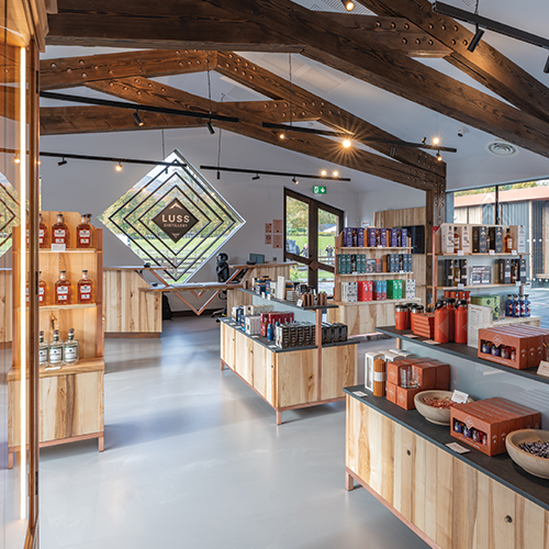 Modern interior of a store with wooden shelves and product displays.