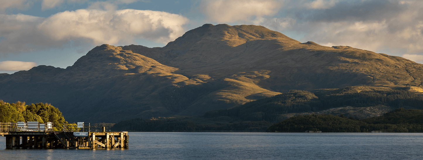 Mountain range with a dock in the foreground on a loch