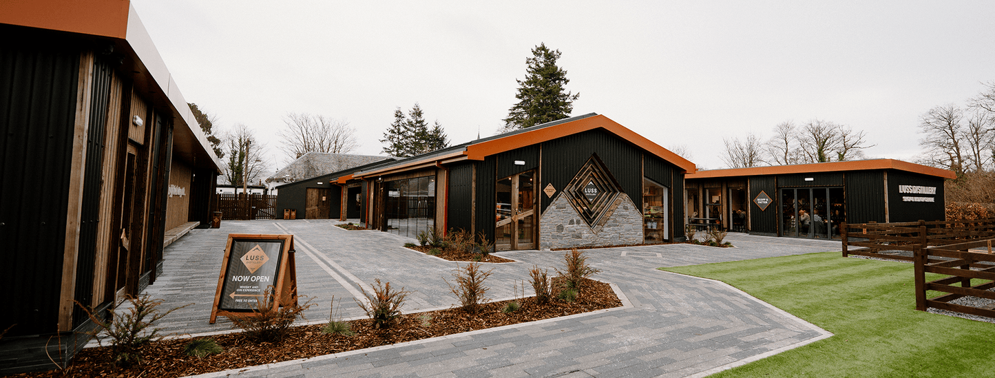 Modern building exterior with a driveway and landscaping
