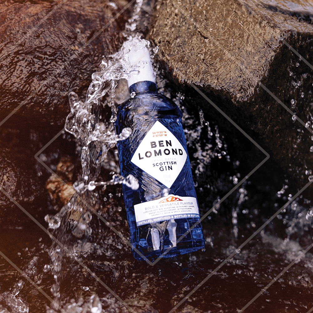 Ben Lomond Scottish Gin bottle being submerged in water with a rocky background