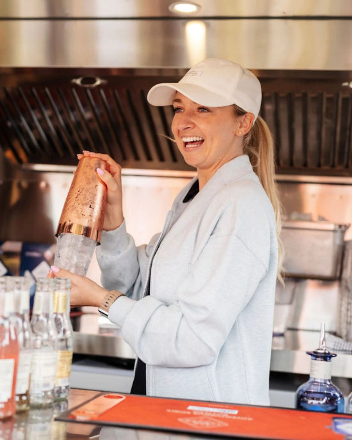Person in a kitchen setting holding a copper container